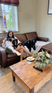 Lady and Dog on holiday cottage sofa